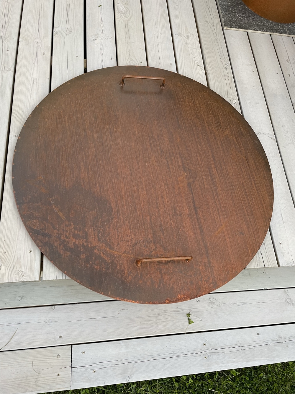 Corten stål, 2 mm lokk, 110 cm diameter. Holder vann, blader og annet ute. Hindrer spredning av glør.